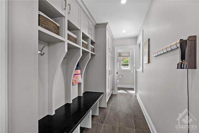 Mudroom with heated floors, Deslaurier cabinetry, access to garage and backyard. | Image 15