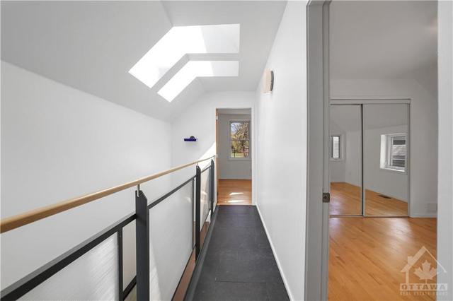 Hallway and catwalk to  2 other bedrooms and a huge main bathroom . This part that is skylight looks down to the living rooms. | Image 22