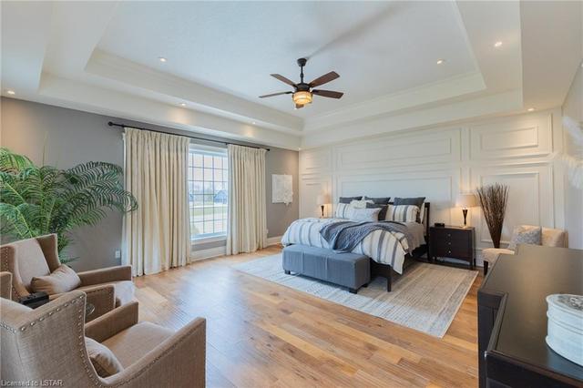 Retreat to the private and oversized primary wing, where more luxury details await. Here, you'll find a large walk-in closet and lavish 5-piece ensuite with heated floors. Enjoy quality wainscoting, large windows overlooking backyard and greenspace | Image 22