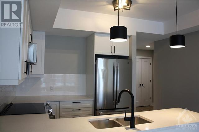 Pendant lights over the u-shaped kitchen | Image 18