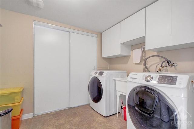 Main Level Laundry area with additional storage. | Image 26