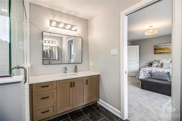 Spa-like ensuite with two vanities & tiled walk-in shower | Image 18
