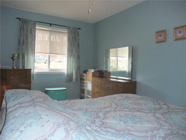 Primary bedroom with a large window. | Image 8