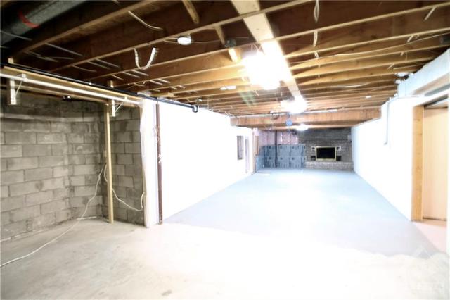 partially finished basement with wood fireplace and walk out to backyard | Image 25