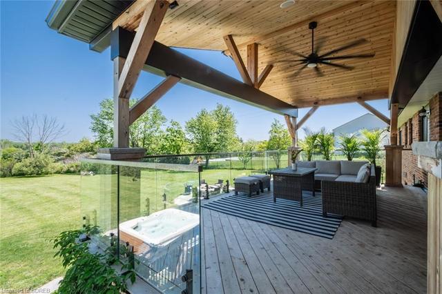 Upper back deck has stairs to the hot tub and backyard | Image 36