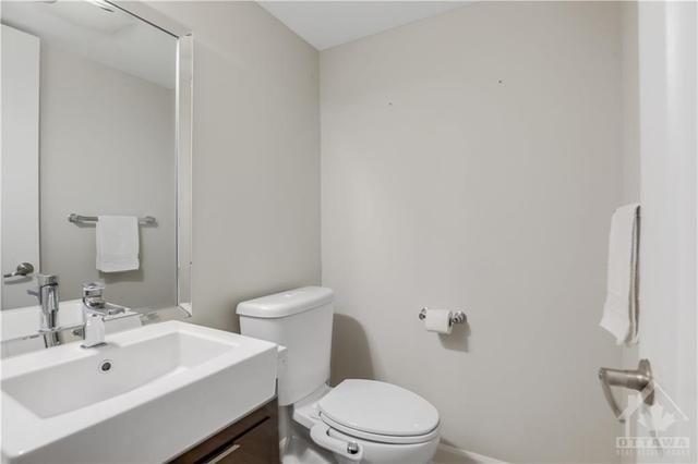 a convenient powder rooms on the main level is adjacent the main floor office/den or 3rd bedroom | Image 23