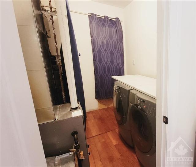 Laundry/utility room with natural gas furnance, hot water tank & electrical panel & access to crawl space located here | Image 17