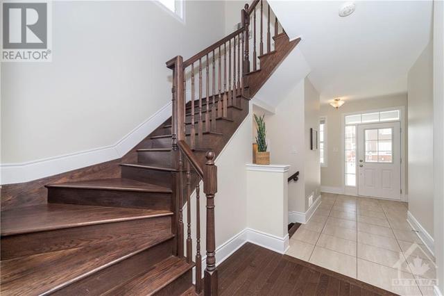 Right this way to the second level. Rich oak hardwood stairs add instant elegance. | Image 3