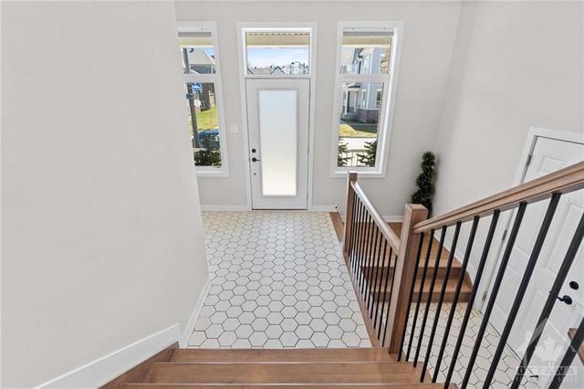 Bright front foyer steps up into living room or down into the lower level walk-out w/ inside access to 2 car garage! | Image 6