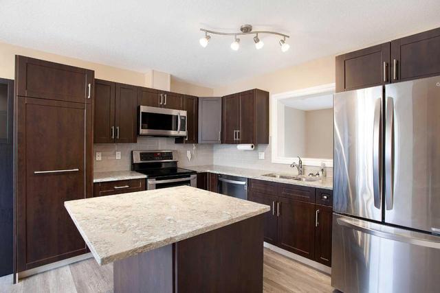 71 Cougar Ridge Mews Sw, Home with 2 bedrooms, 1 bathrooms and 2 parking in Calgary AB | Image 8