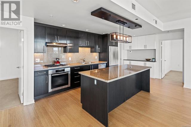 Kitchen with quality Miele & KitchenAid appliances, plus granite countertops & backsplash. | Card Image