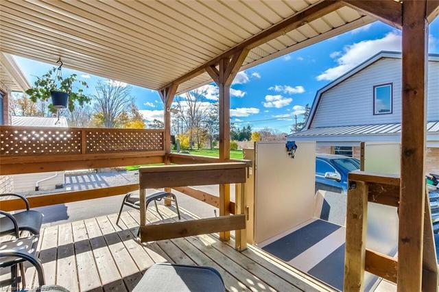 Covered  back deck with view garage covered porch | Image 17