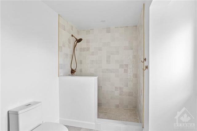 The primary suite features a lavish bathroom with herringbone tile, a custom white oak (grain matched) floating vanity with double Pearl sinks and a walk in shower with a hidden drain (shower and | Image 18