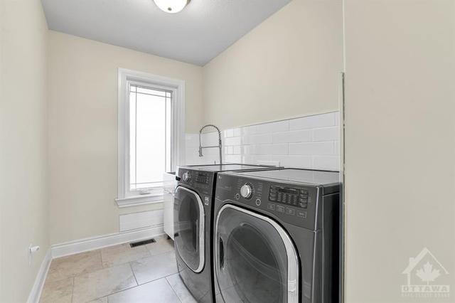 Main floor laundry in mud room area | Image 5