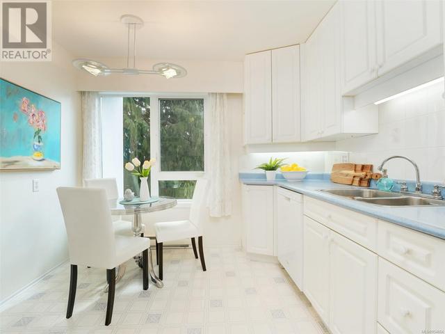 Kitchen - Bright, with eating w/large window and area for table and chairs. | Image 8