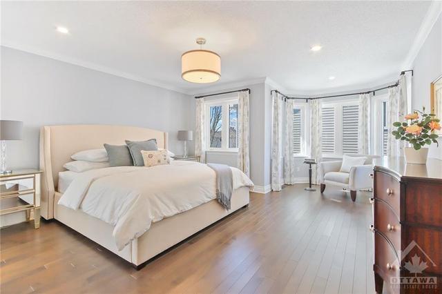 Ultra spacious Primary bedroom retreat with sitting area, crown moulding and recessed lighting | Image 16