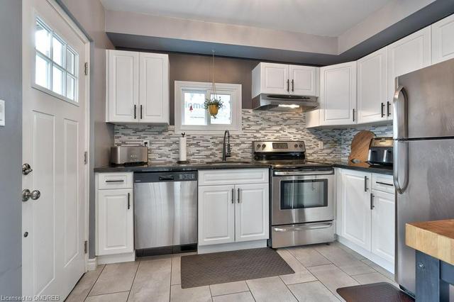 The Kitchen Features Granite Countertops and a Designer Backsplash | Image 27