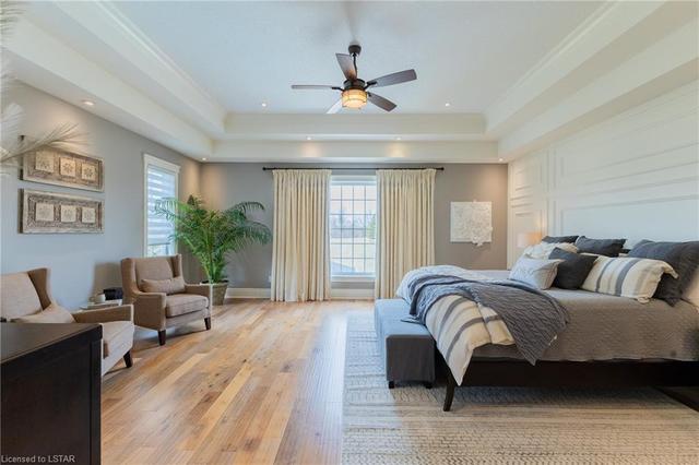 Retreat to the private and oversized primary wing, where more luxury details await. Here, you'll find a large walk-in closet and lavish 5-piece ensuite with heated floors. Enjoy quality wainscoting, large windows overlooking backyard and greenspace | Image 21