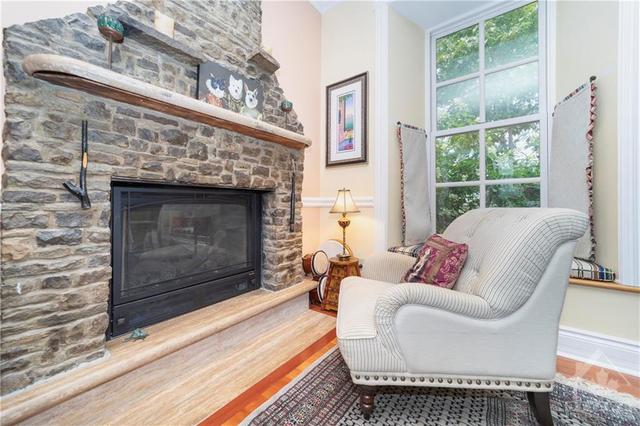 Cozy Double sided Gas fireplace with historical stone and large bright windows | Image 8