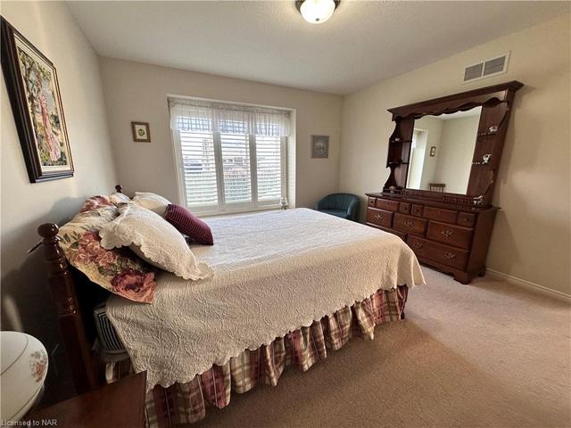 The primary bedroom is carpeted and has its own 4-piece ensuite. | Image 13