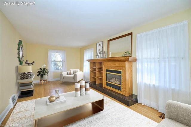 Gleaming Hardwood Floors with Gas Fireplace Virtually Staged | Image 33