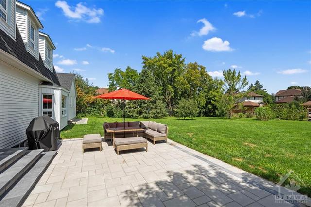 The fully fenced rear yard is generously sized. Some recent updates include all new 35 year Architectural shingles; a 24' x 28' interlock patio with 3 tier steps; a new wrap around walkway and mat | Image 28