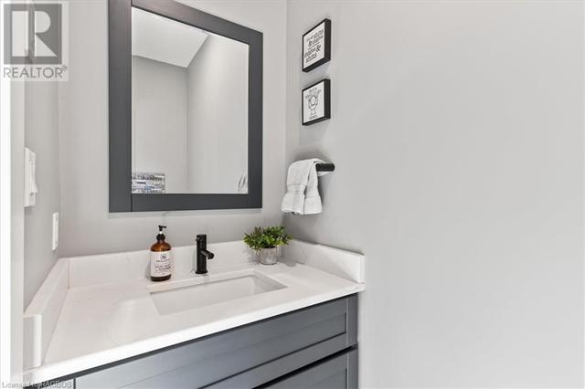 2 piece main floor bathroom off the garage and laundry room | Image 15
