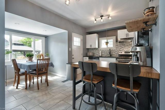 Kitchen Adorned with Stainless Steel Appliances and Easy Access to the Deck | Image 26