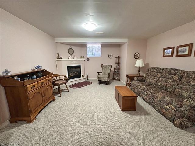 The basement offers a good size recreation room with gas fireplace. | Image 22