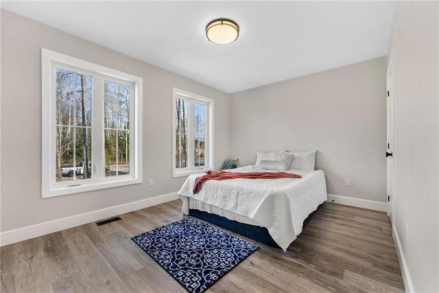 Bright bedroom overlooking front yard. Could be a den or office. | Image 14