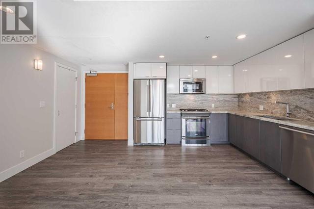 Open concept with granite, backsplash and upgraded appliances including gas stove | Image 4