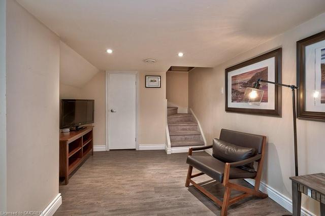 The Durable Vinyl Flooring in the Partially Finished Basement Offers a Touch of Luxury | Image 8