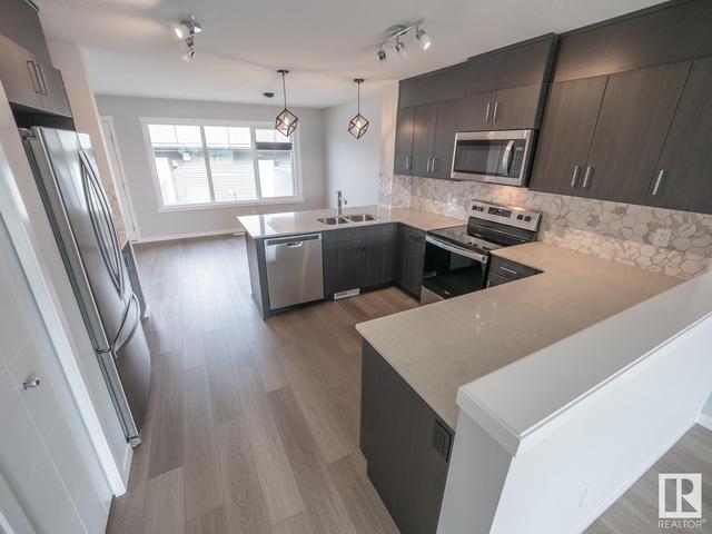 5694 Juchli Av Nw, House attached with 3 bedrooms, 3 bathrooms and null parking in Edmonton AB | Card Image