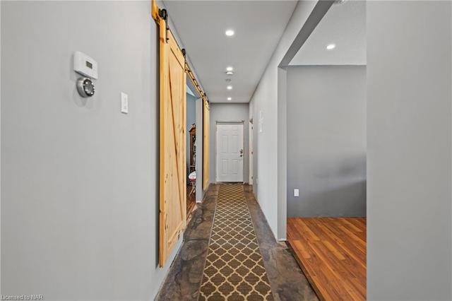 Hallway to Office, Primary Bedroom, Laundry, Bathroom and Garage | Image 16