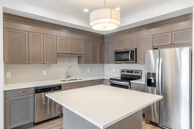 208 - 30 Shawnee Common Sw, Condo with 2 bedrooms, 2 bathrooms and 1 parking in Calgary AB | Image 8