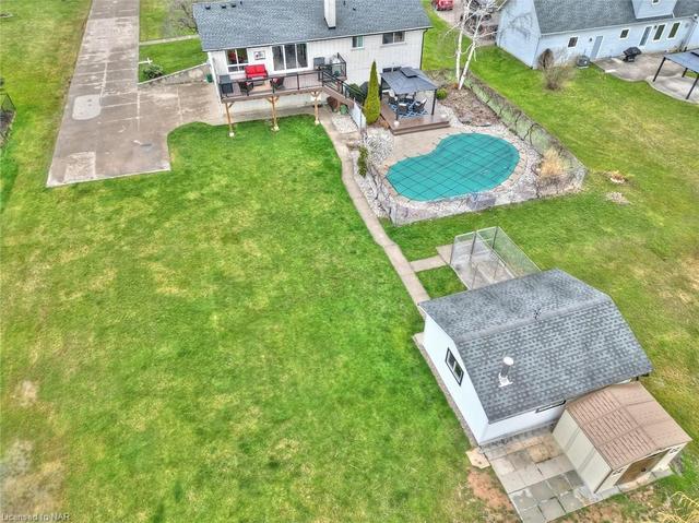 overhead shot of back yard, upper deck, gazebo, in-ground pool, out building and garden shed | Image 12