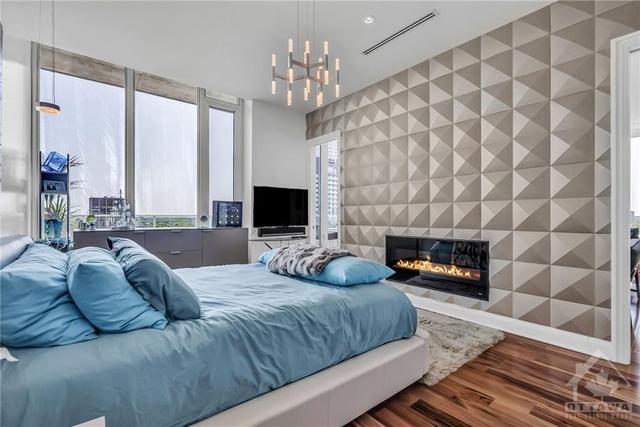 Accent wall with a fireplace and a luxurious soundpoof panelling. | Image 19