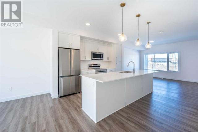 1861 Na'a Drive Sw, House attached with 3 bedrooms, 2 bathrooms and 2 parking in Calgary AB | Image 5