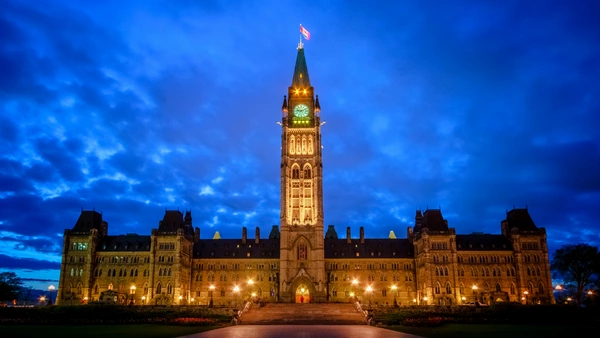 New Federal Housing Initiatives to Watch for in 2023 Blog Hero. A photo of the parliament building with the lights on during a cloudy night.