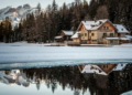 A large snowcovered home on a lake