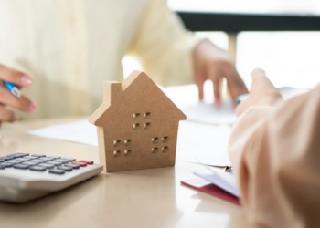 A picture of a calculator and a small wooden house.