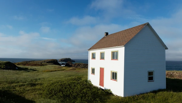 A house overlooks the ocean.