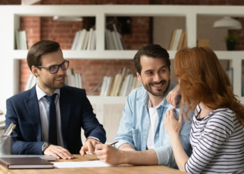 A couple in a meeting with a real estate agent.