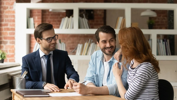 A couple in a meeting with a real estate agent.