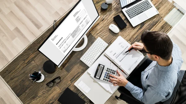 A person sits at a desk doing their taxes.