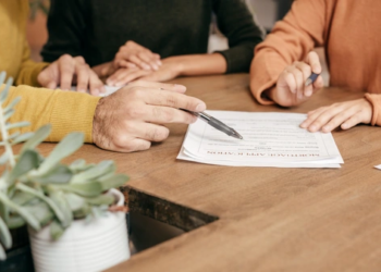 A group of people looking at a mortgage application form.