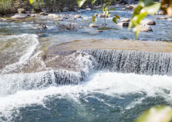 a river with a small waterfall