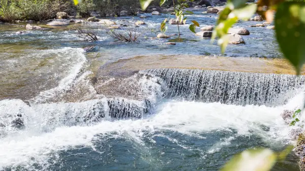 a river with a small waterfall