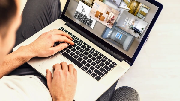 A person searches on a laptop different home types
