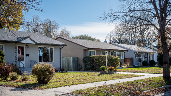 A row of bungalows on a street.